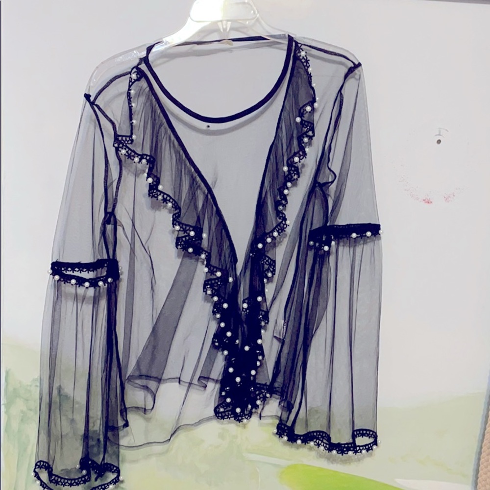 Black sheer top with decorated pearls.